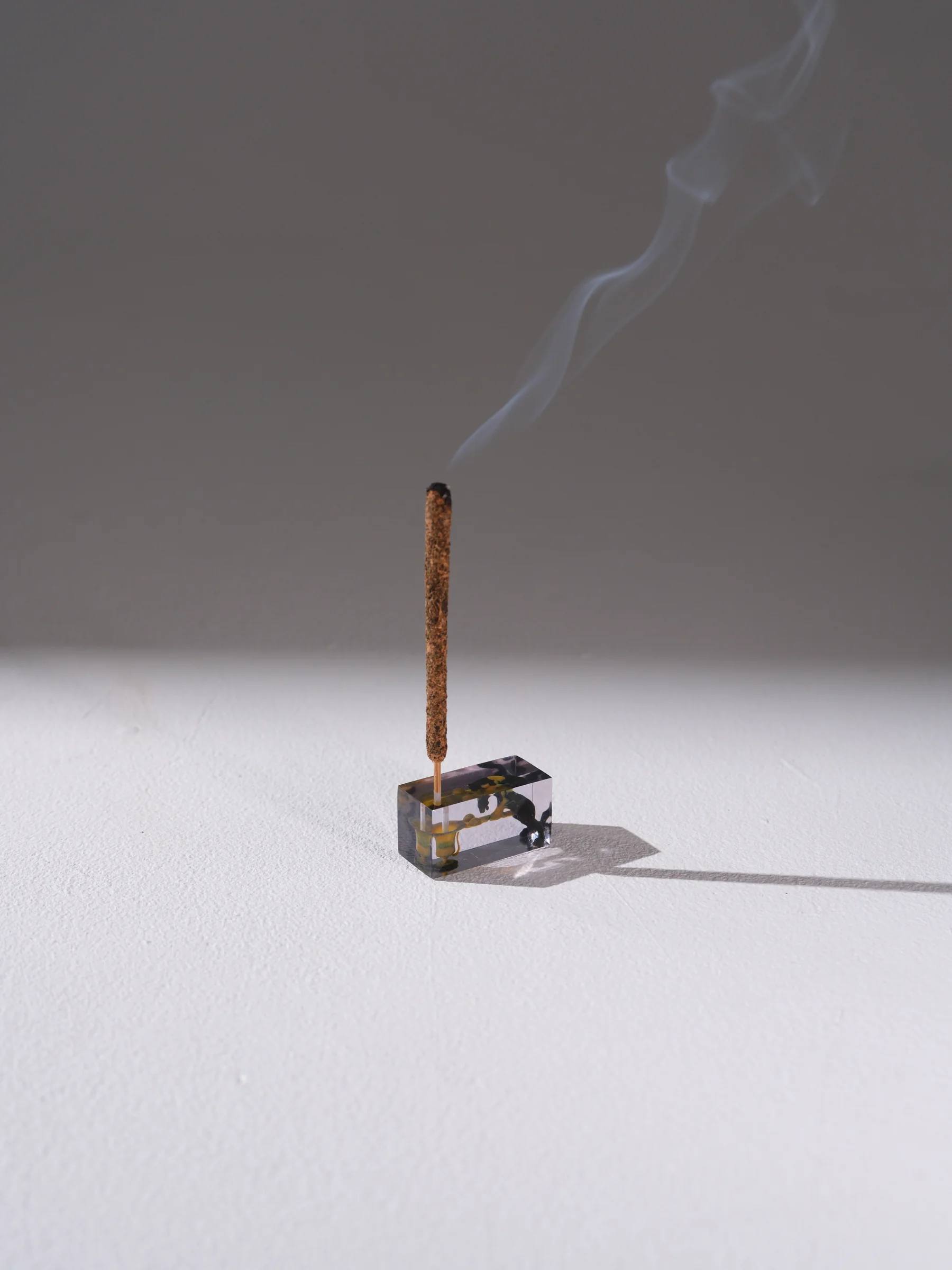Single hybrid incense object emitting smoke