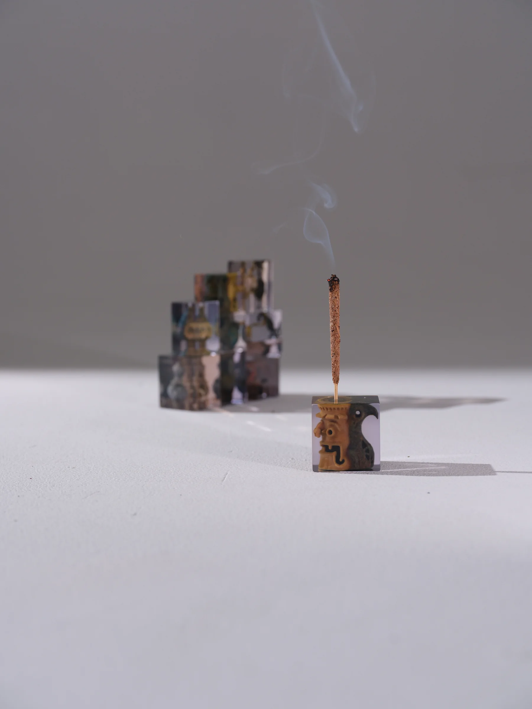 Two Syncret incense objects emitting smoke