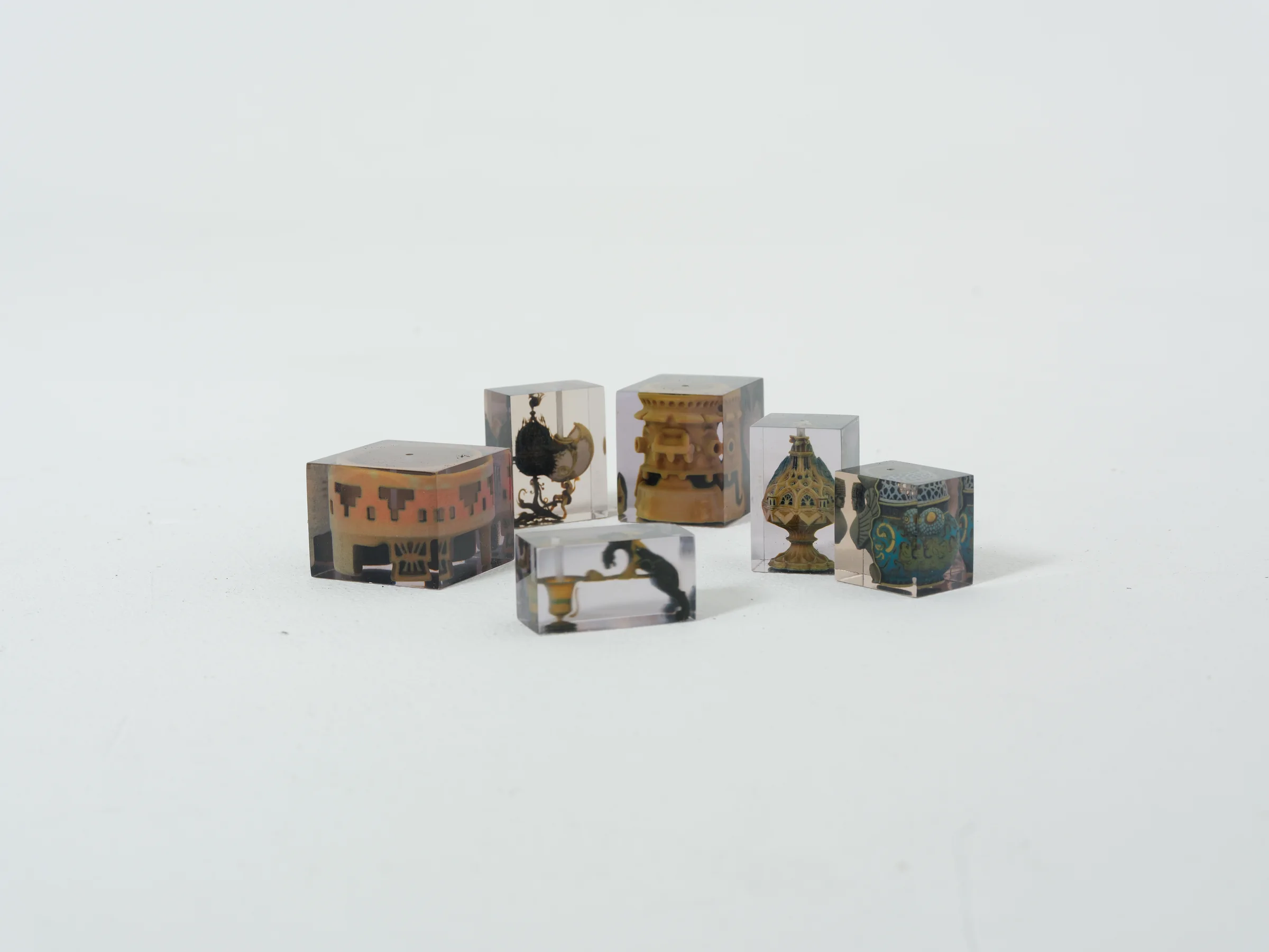 A group of Syncret incense objects on a white surface